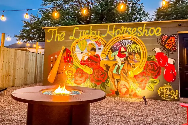 Urban Cottage: Backyard fire pit and mural at dusk