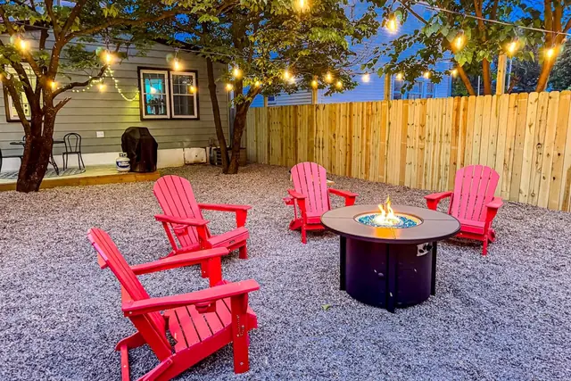 Urban Cottage: Fire pit seating under string lights