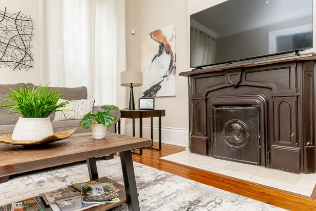 Historic 4BR Brick Home: Living room with antique fireplace