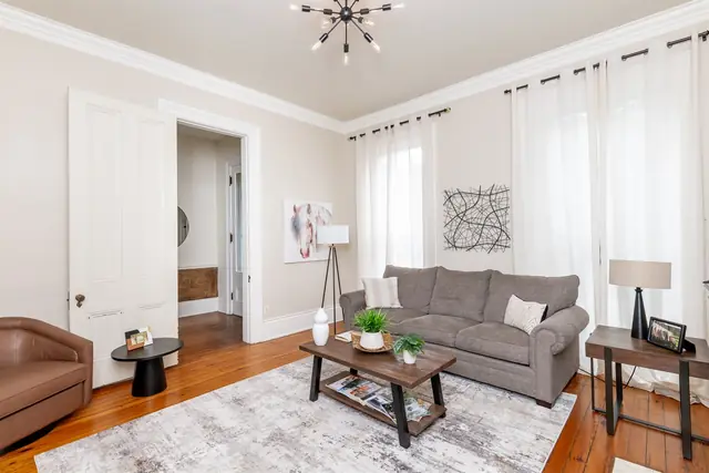 Historic 4BR Brick Home: Living room with gray sofa