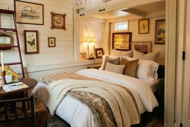 Cozy Cottage off Frankfort Ave | Louisville Studio: Bedroom with queen bed and vintage art