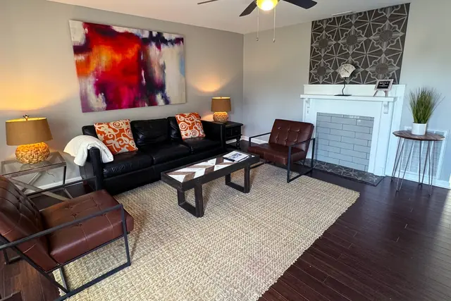Germantown Luxury Retreat: Living room with leather sofa and fireplace