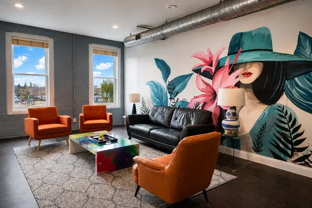 Nulu Marketplace Double Play: Vacation Rentals Louisville KY: Living room with orange armchairs and mural