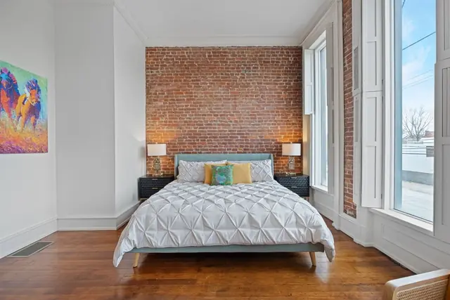 The Grand Slam: Bedroom with exposed brick