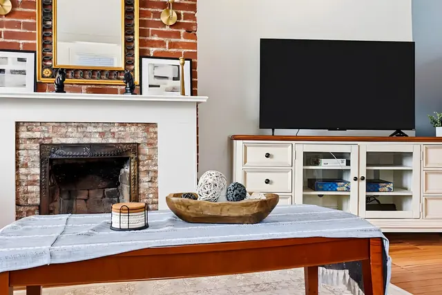 Historic Louisville 5BR Grand Charm Retreat: Living room with TV and fireplace