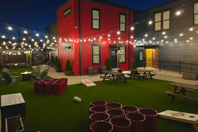 Rooftop Stay: Courtyard lawn with games and string lights