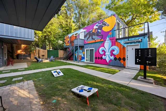 Entire 6-Unit NULU Complex | Private Group Buyout | Sleeps 16: Lawn with cornhole and mural