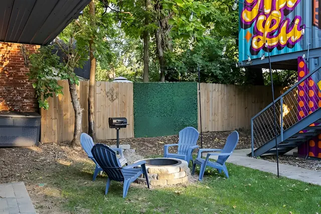 Modern Shipping Container Stay in NuLu | Unit 3: Fire pit seating by the mural staircase