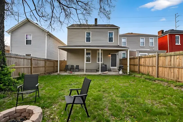 Elegant 2 Bedroom Garden Suite Historic Louisville | Sleeps 6: Backyard lawn with fire pit and chairs