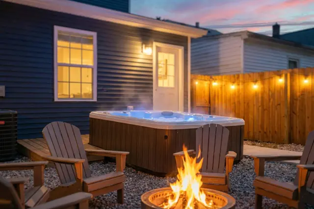 Spacious 3BR BNB Louisville | Near Expo, Derby & Downtown: Backyard hot tub and fire pit at dusk