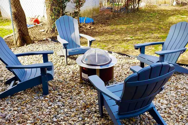 Germantown Luxury Retreat: Backyard fire pit with Adirondack chairs