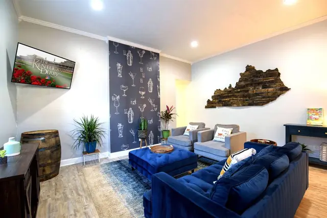 The Julep House NuLu: Living room with TV and Kentucky wall art