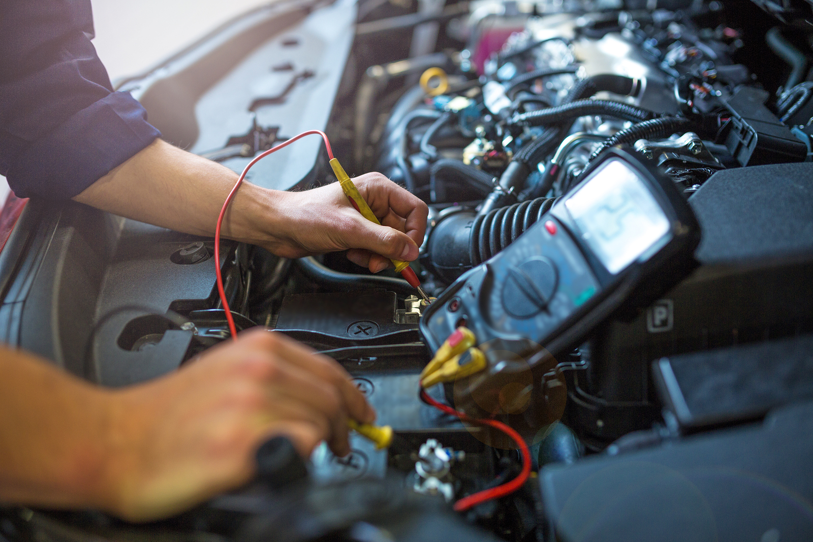 mechanic testing car battery