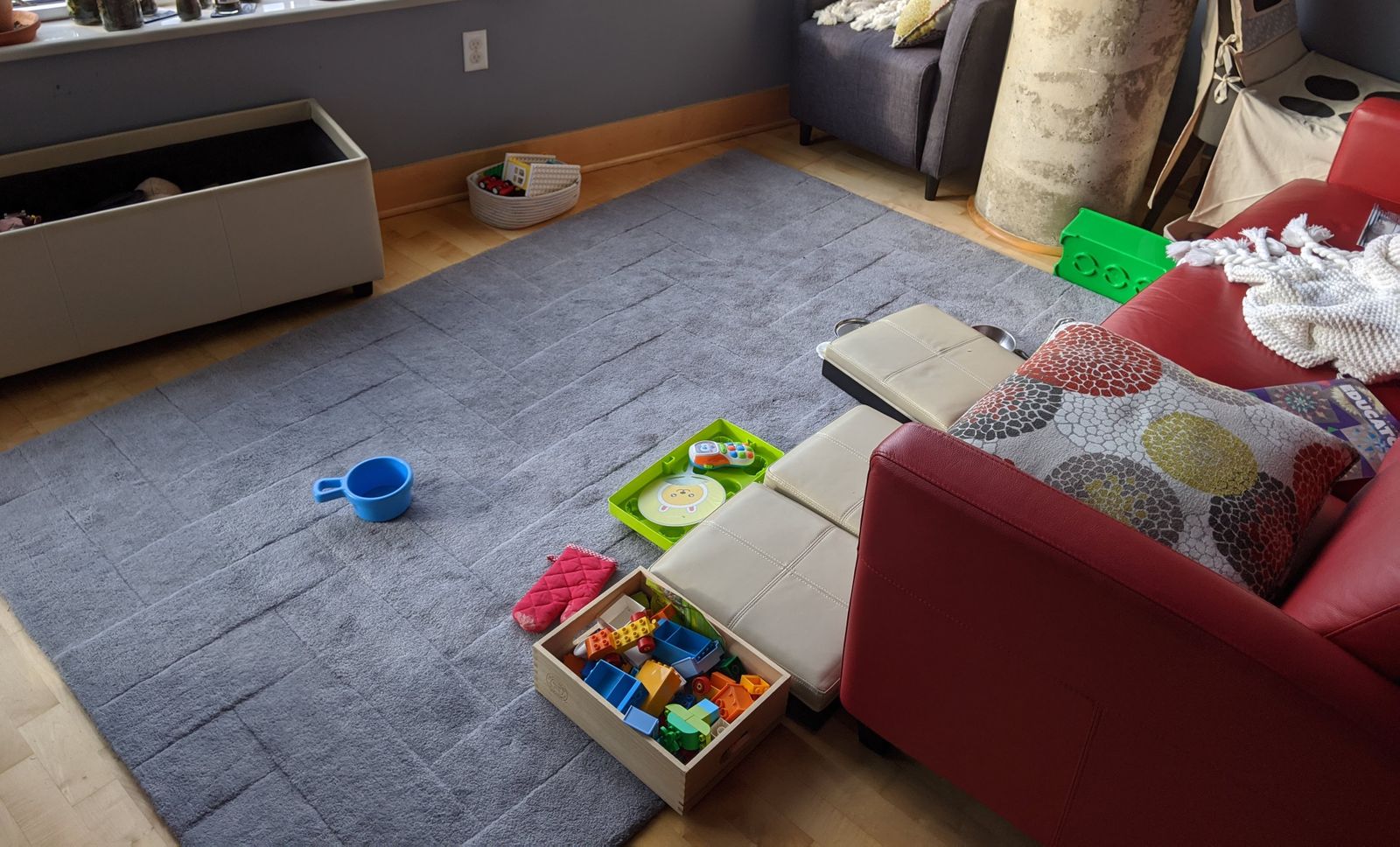 The toy chest doesn't just store toys - it is a toy! Shown here as a couch - complete with her phone right next to her.