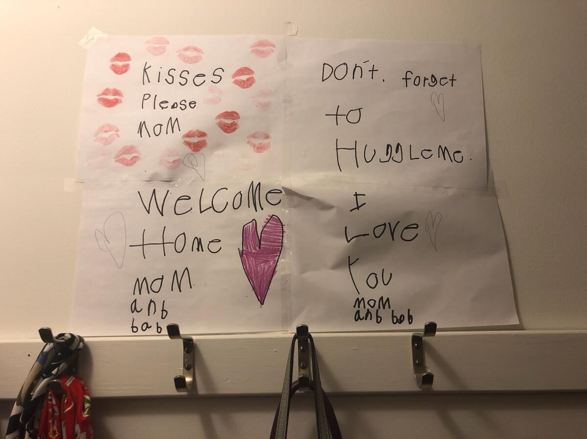 Mom and Bab hang their daughter's art and notes in the closet.