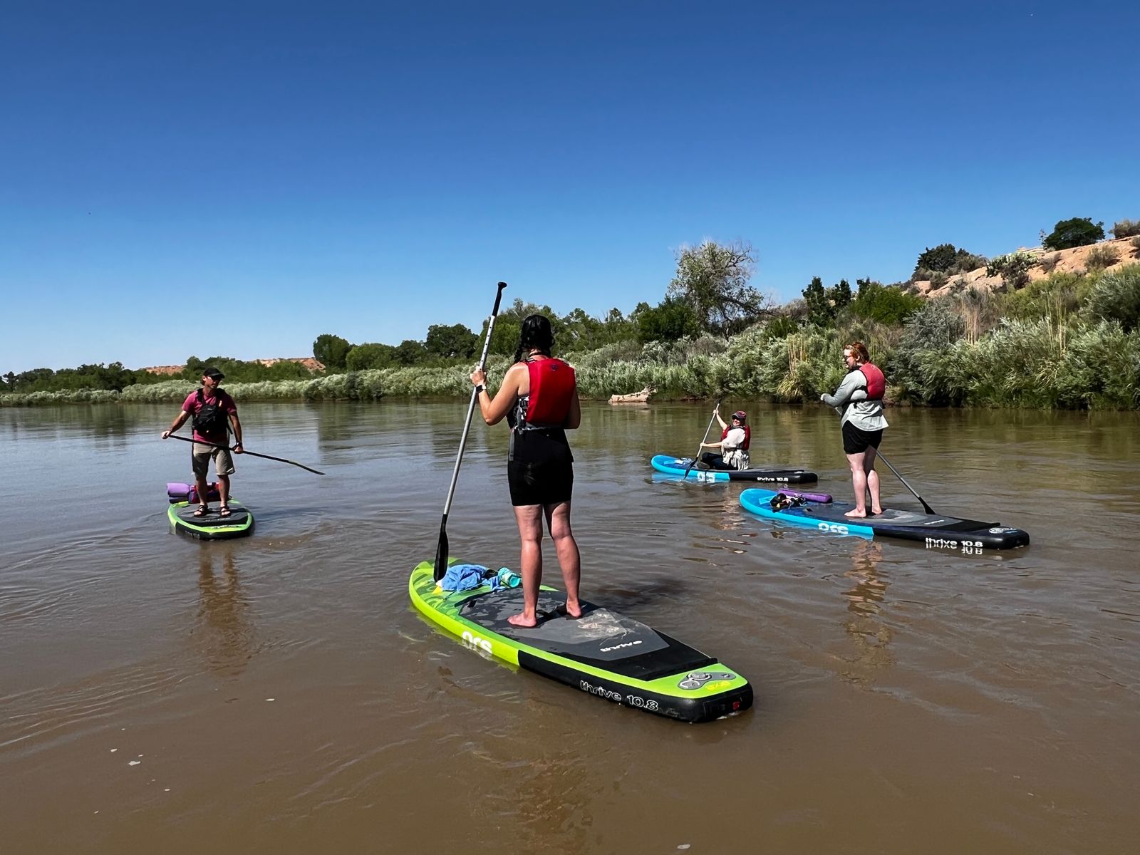 Catch the Wave of Wellness: Yoga and Paddle Boarding on the Rio Grande

Imagine gliding over the tranquil waters of the Rio Grande, the New Mexico sun warming your skin, as you effortlessly combine the tranquility of yoga with the thrill of paddle boarding. This isn't just a fantasy—it's a real adventure waiting for you. Here’s why yoga and paddle boarding on the Rio Grande is the ultimate way to unwind, get fit, and reconnect with nature.

 Paddle-boarding truly is a fantastic workout! Balancing on the board engages your core muscles, improving strength and stability. Every tiny wave or ripple challenges your balance, making your muscles work even harder. This unique combination targets muscles you might not even know you had, from your shoulders and arms to your legs and abs. It's like hitting the gym, but way more fun and scenic.
In our sessions on the river, we'll practice a 60-minute yoga class on the beach. 
During lake excursions we will practice yoga on the on the paddleboards. 
Everything is optional. 

There’s something incredibly soothing about the water. The gentle rocking of the paddleboard and the rhythmic sound of the river can melt away stress and anxiety. Practicing yoga in this serene environment helps clear your mind and enhances mindfulness. The natural surroundings—towering cottonwoods, chirping birds, and the occasional glimpse of wildlife—provide the perfect backdrop for meditation and relaxation. This escape from the daily grind is a powerful antidote to the stresses of everyday life.

The Rio Grande is a majestic river with a rich history and vibrant ecosystem. By practicing yoga on the beach and paddle-boarding, you’re not just working out—you’re also immersing yourself in nature. You’ll feel a deeper connection to the environment as you float past breathtaking landscapes and soak in the beauty of the New Mexican wilderness. This adventure encourages you to appreciate and protect the natural world, fostering a sense of stewardship for our planet.

Why Sign Up for a Class?
You might be thinking, “This sounds great, but where do I start?” Here’s why you should sign up for a class:
* Guided Experience: Qualified instructors can teach you the basics of both paddle boarding and yoga, ensuring you’re safe and confident on the water. They’ll help you find your balance, literally and figuratively.
* Community Vibes: Joining a class means you’re not alone. You’ll meet like-minded people who share your interest in fitness and the outdoors. It’s a fantastic way to make new friends and build a supportive community.
* All Equipment Provided: Don’t have a paddleboard? No problem. Classes provide all the necessary equipment, so you can just show up and enjoy the experience without any hassle.

So, are you ready to catch the wave of wellness? Yoga and paddle boarding on the Rio Grande offer a unique and enriching way to stay fit, reduce stress, and connect with nature. It’s a workout for your body, a balm for your mind, and a feast for your soul. Don’t miss out on this extraordinary adventure. 
Sign up for a class today, and let the river guide you to a healthier, happier you.
