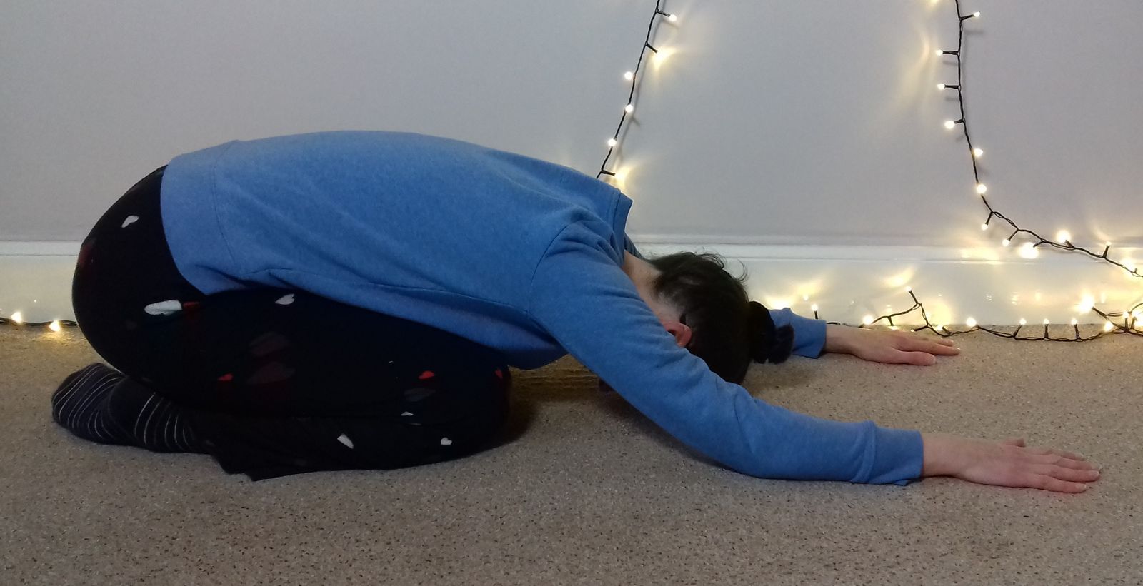 Image: Balasana with arms in front (some call this ancestral worship). Here my knees are fairly close together and I'm partially resting on my legs, so you can see the curve in the upper mid back. 