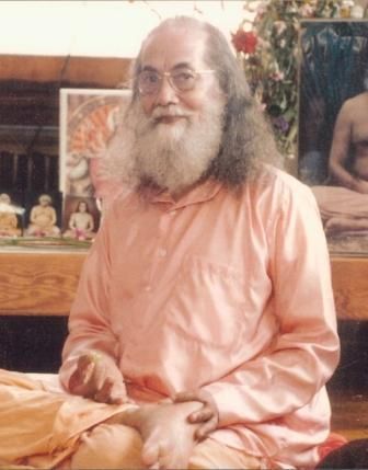 Swami Hariharananda holding a grape