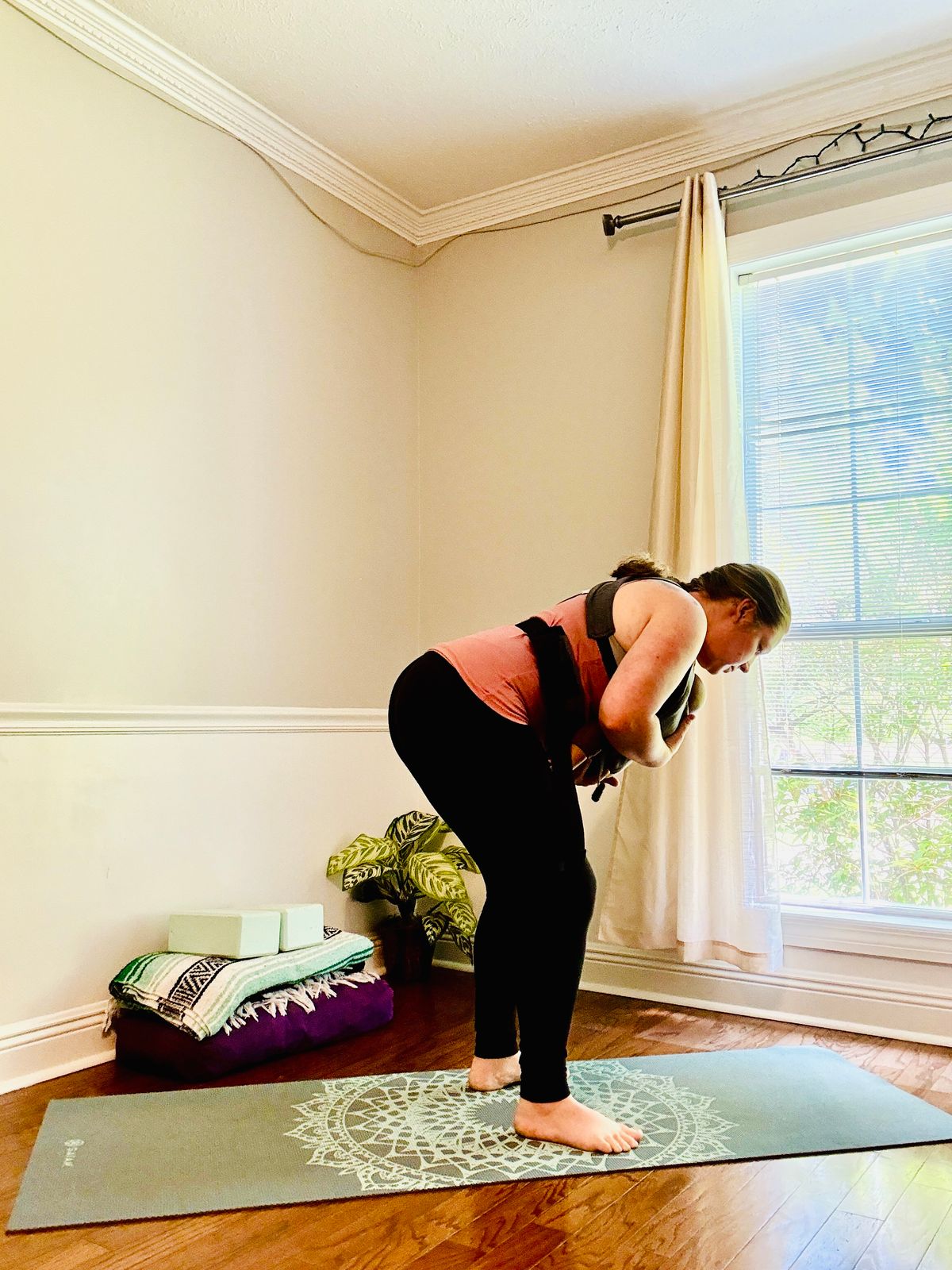 Exhale, half forward fold – Hinge at the hips, spine long, baby supported.
 