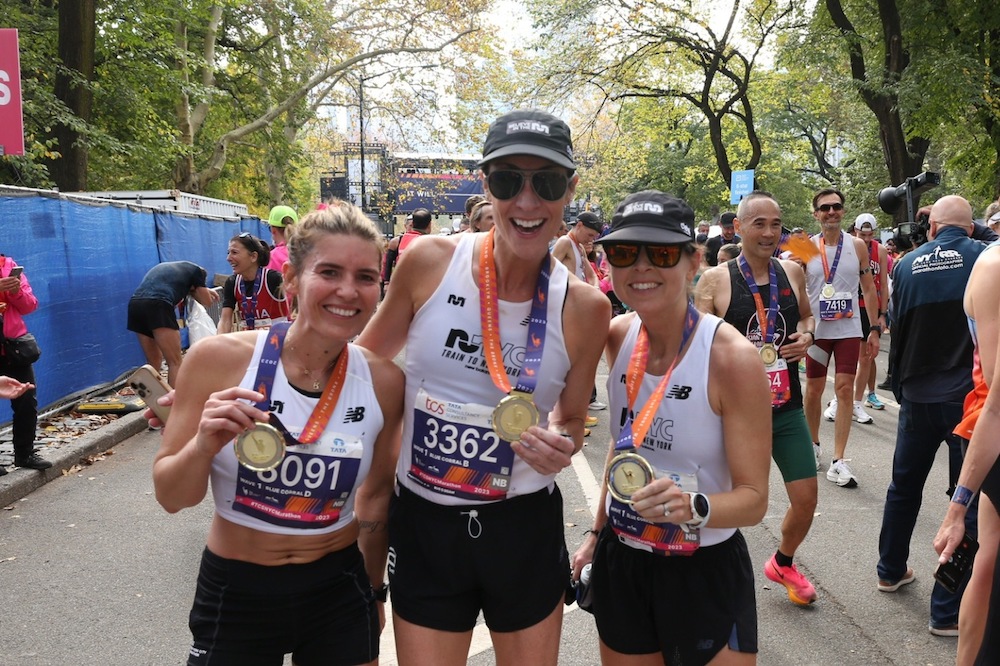 three women with medals at the end of the new york city marathon