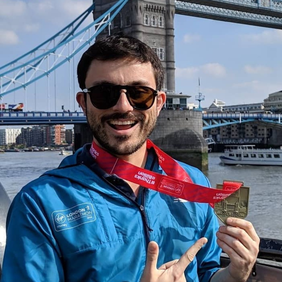 man holding london marathon medal