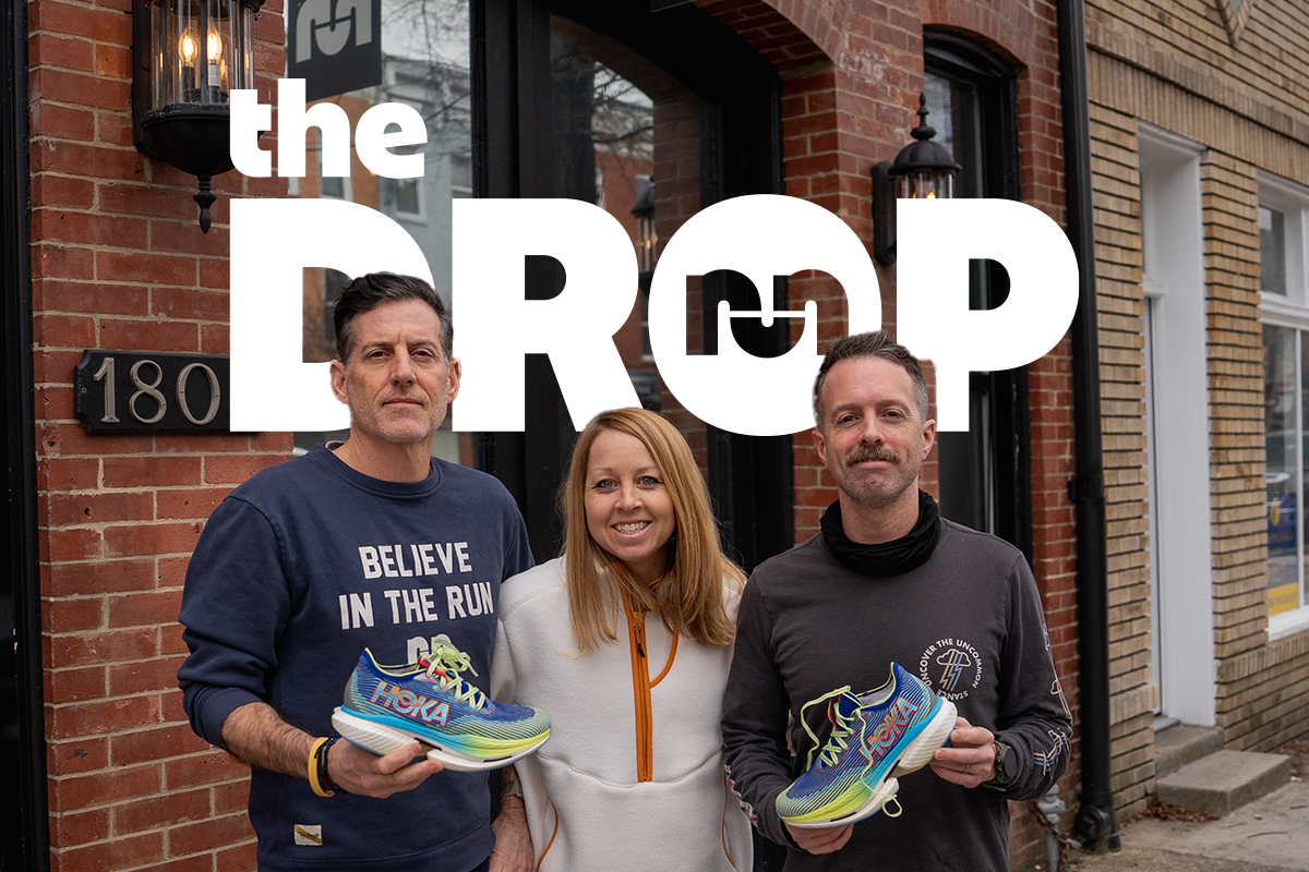 man holding shoe on left, woman smiling in center, man holding shoe on right