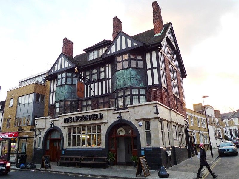 A women walking past a pub on a corner.jpg