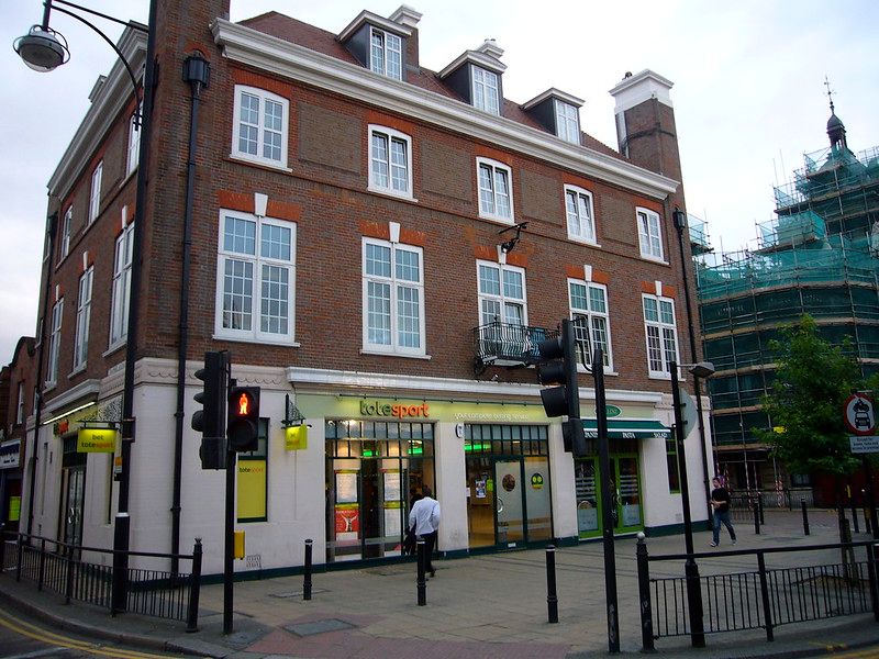 A three-storey building beside a construction site.jpg