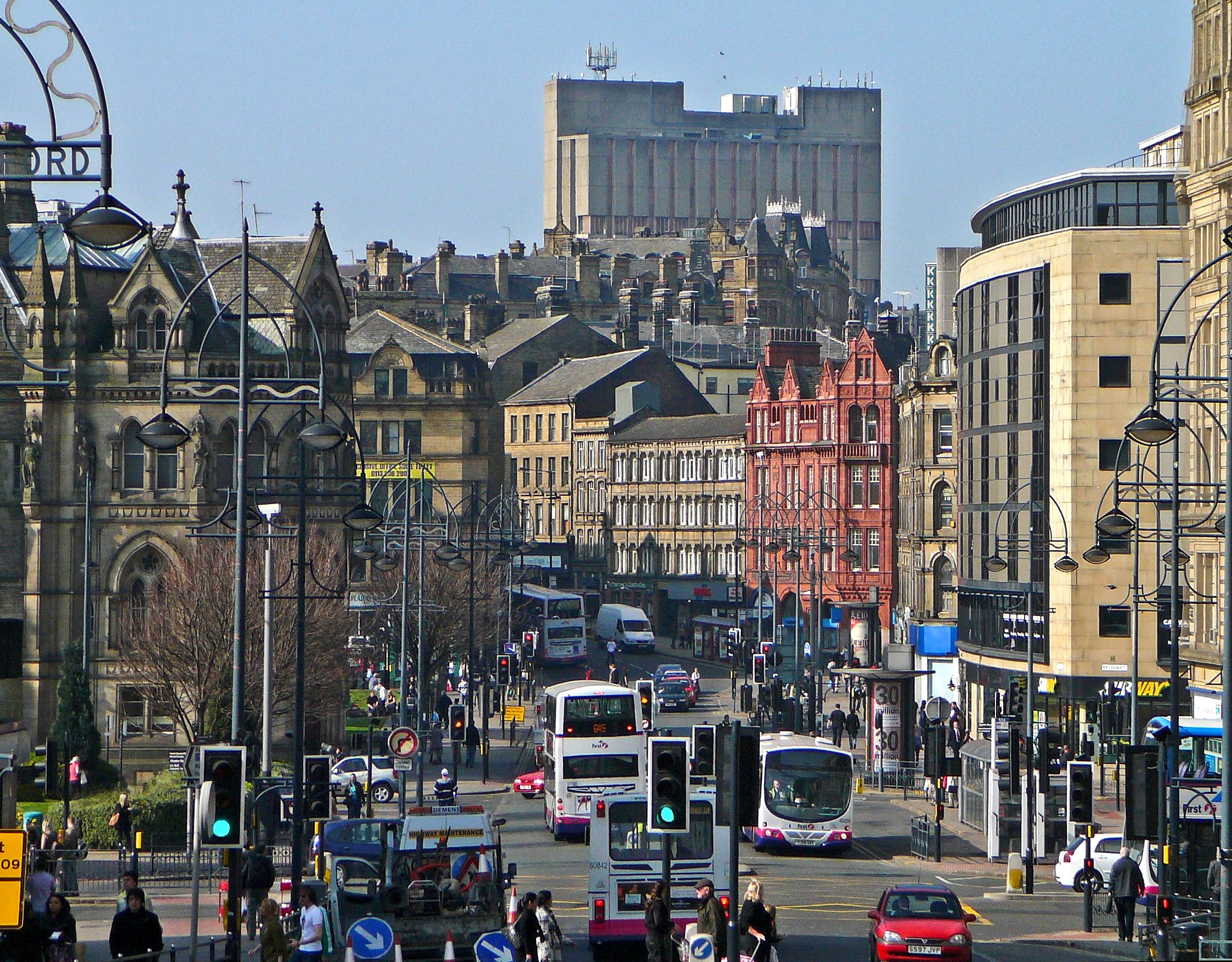 A busy city street with many people and vehicles