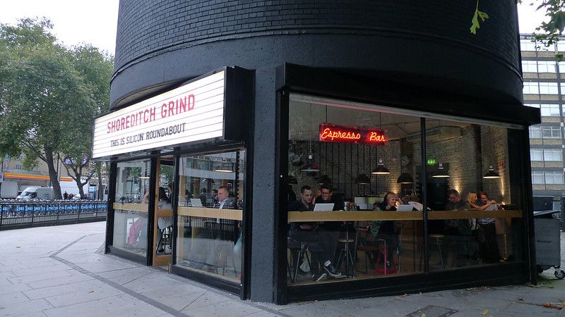 A bar with glass windows near a roundabout.jpg