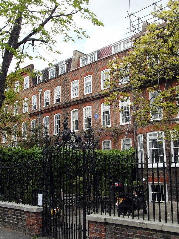 A old 4-storey building behind a fence.jpg