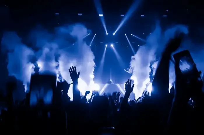 a crowd in front of the stage with lights