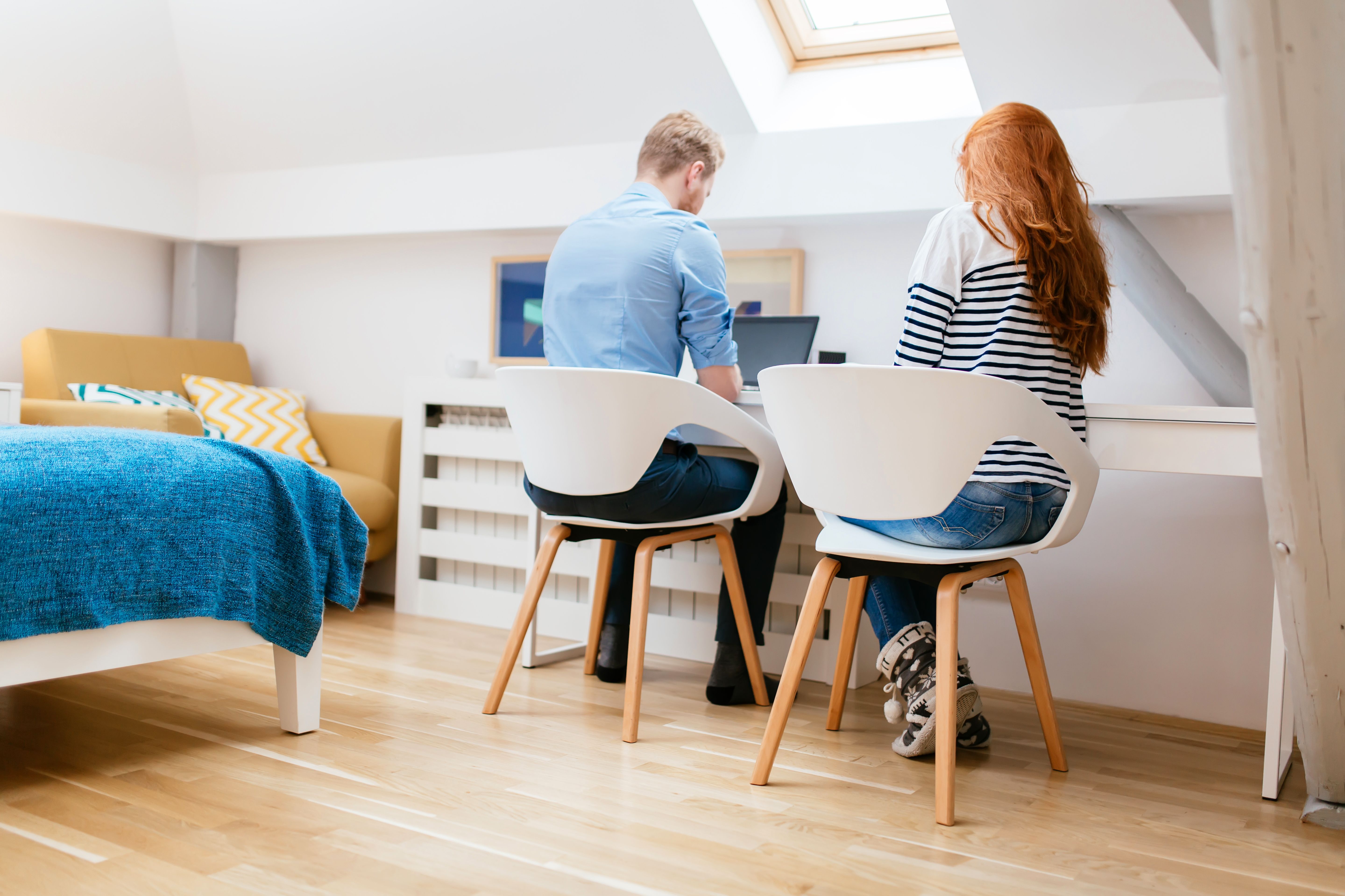 A couple working in a clean, nicely designed home