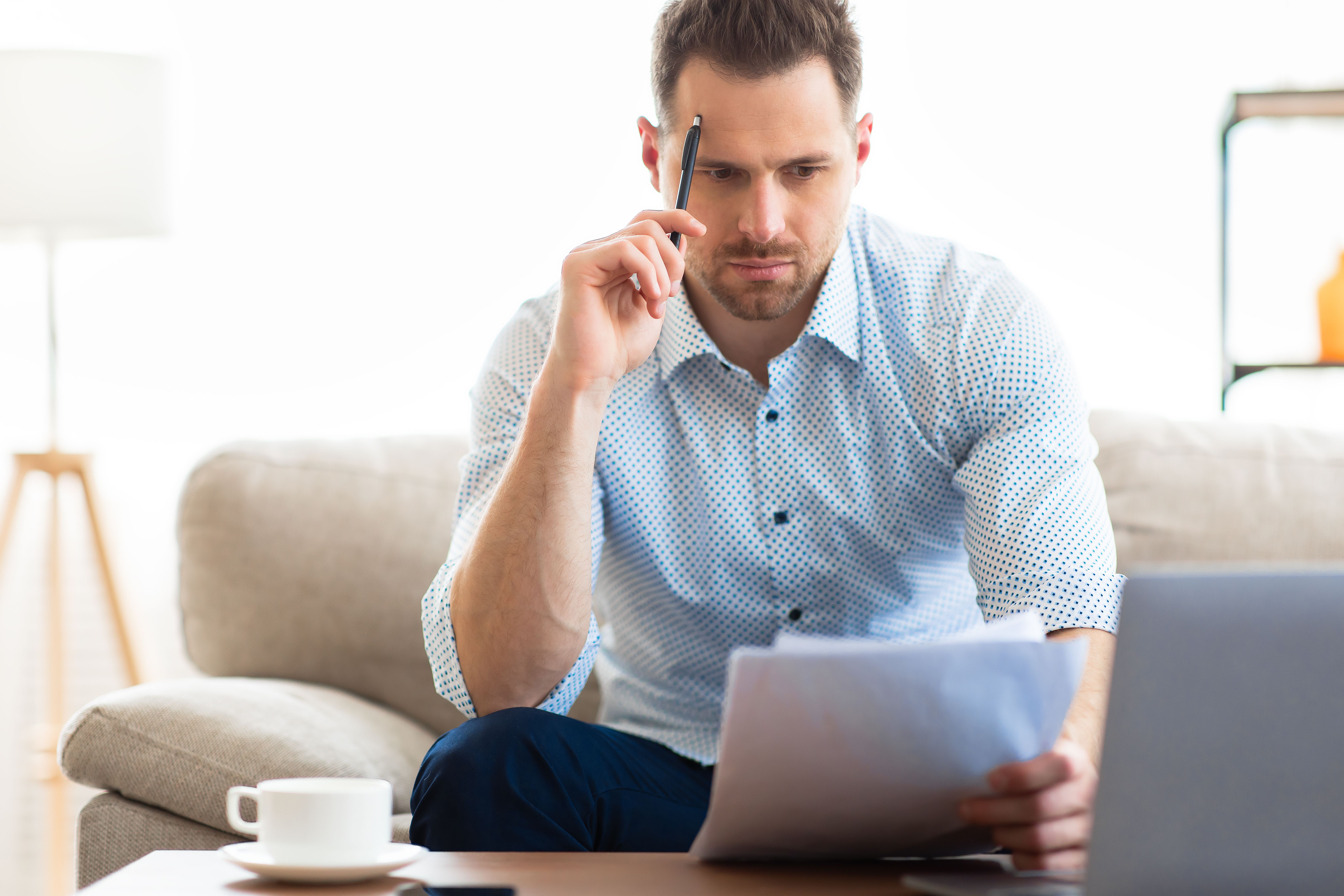 A young man concerned with his 7% rent increase notice at a traditional Private Rental home.