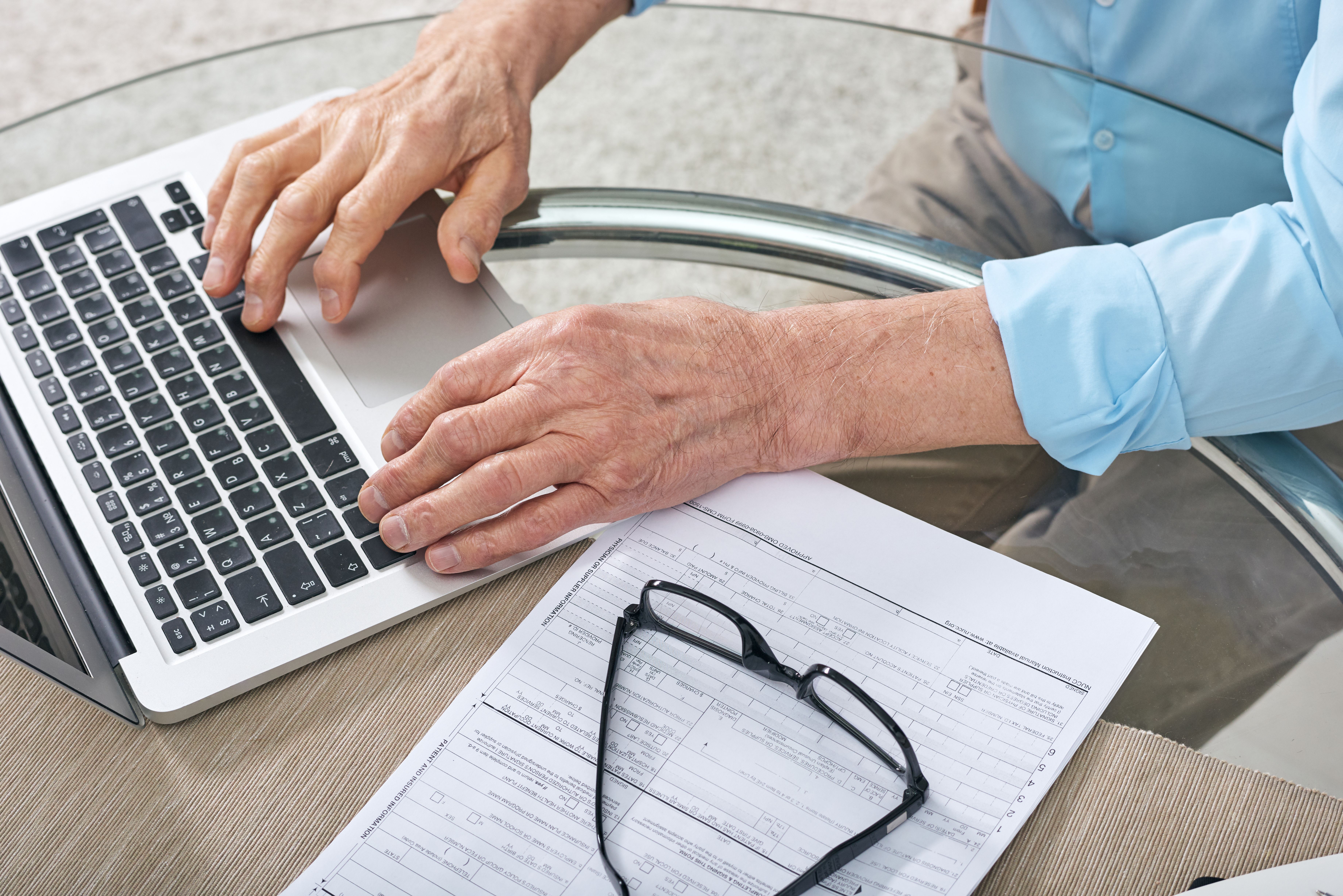 A tenant filling in an online form to challenge his landlord on their decision to increase rent.