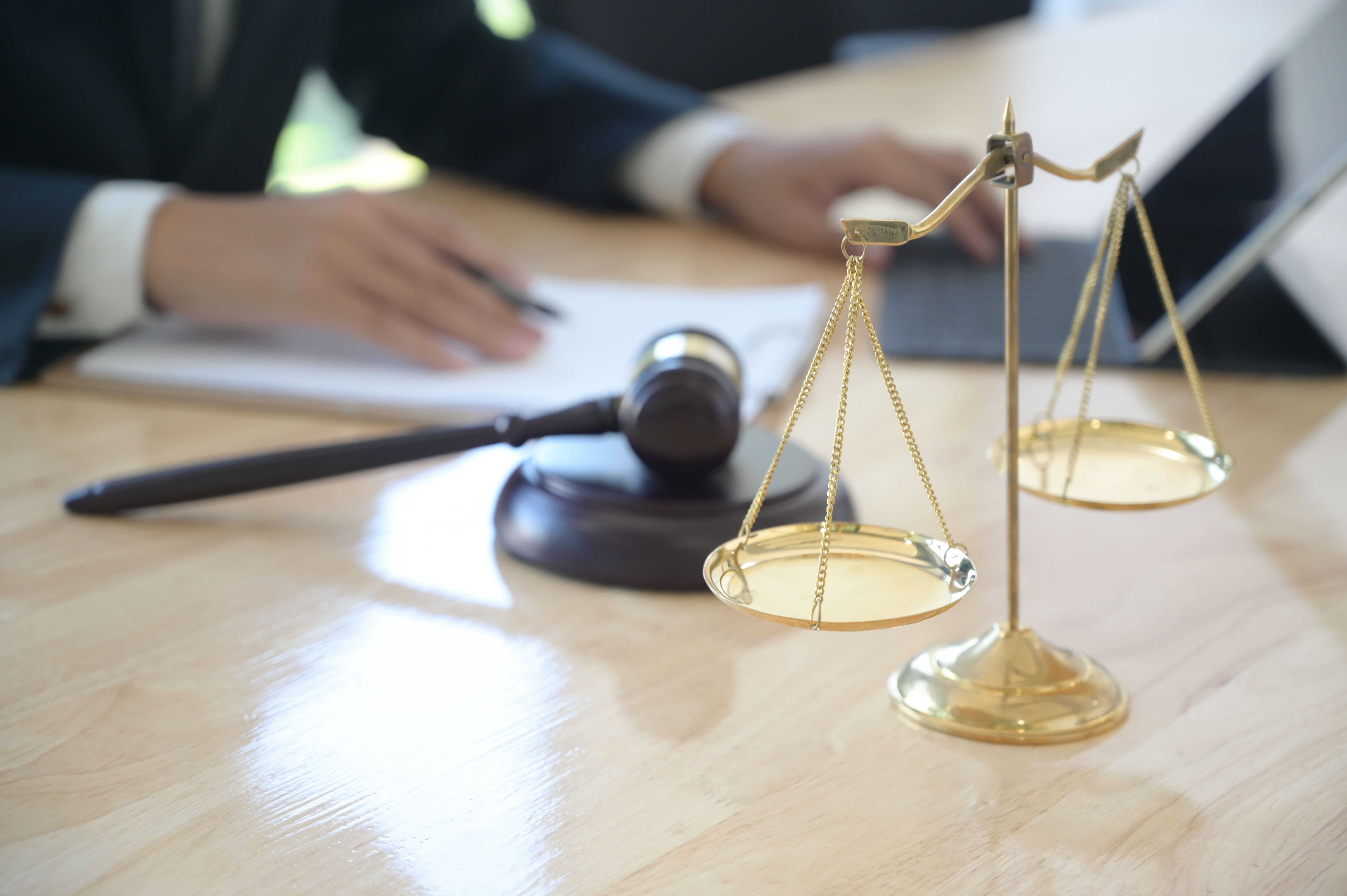 A lawyer working with a hammer on the desk