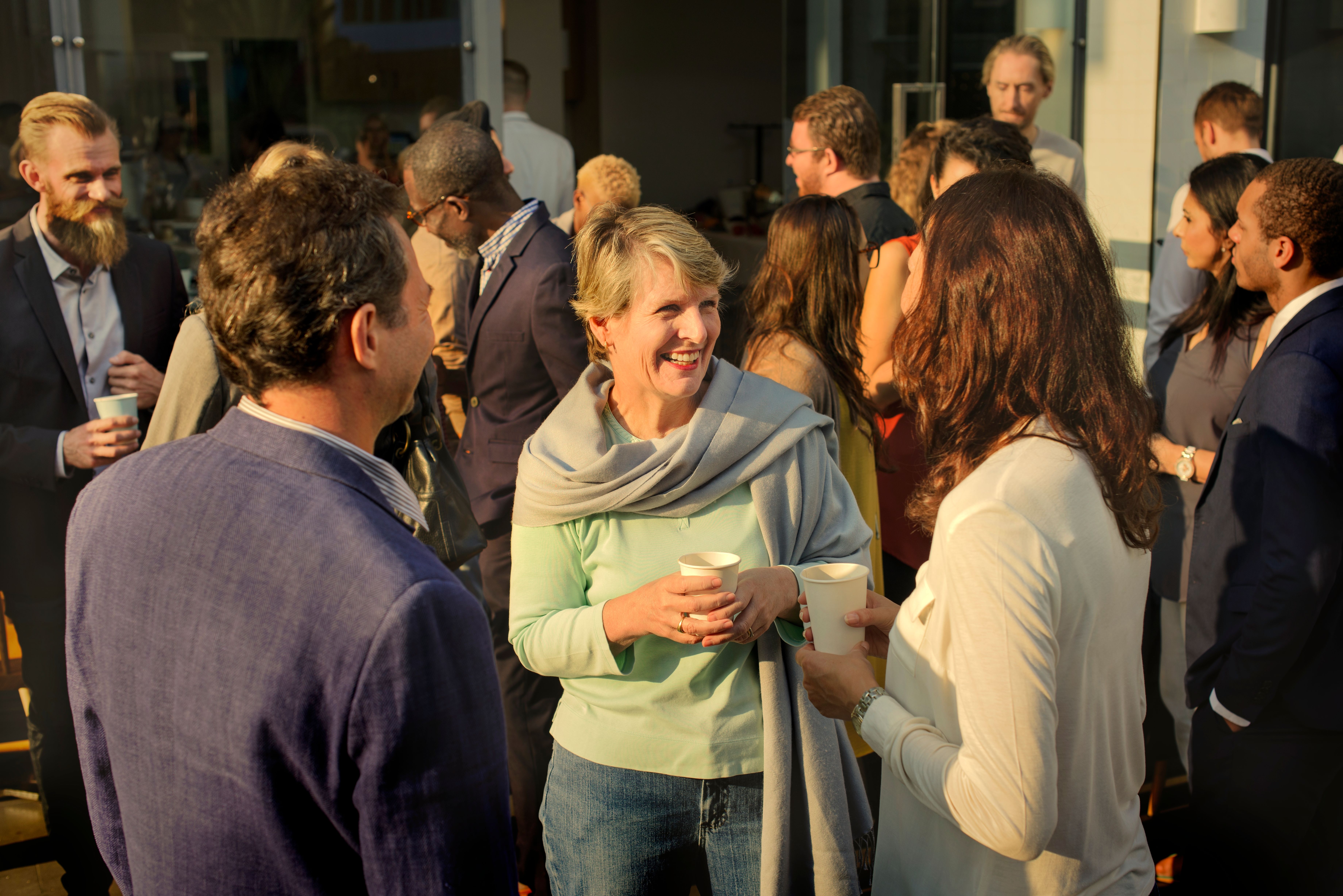 A group of people talking to each other in a friendly community event in their building 