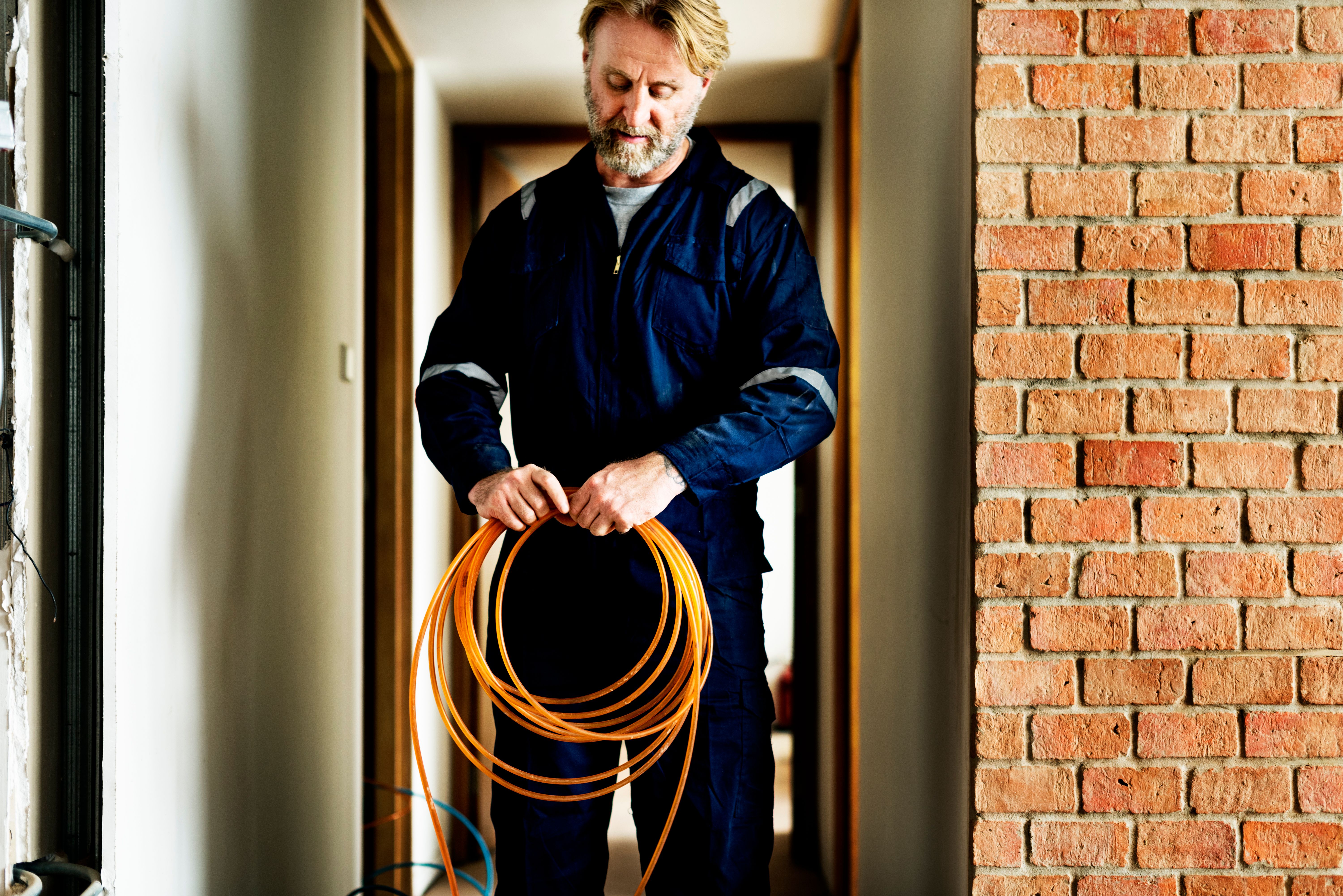 An electrician working on an installation at a house