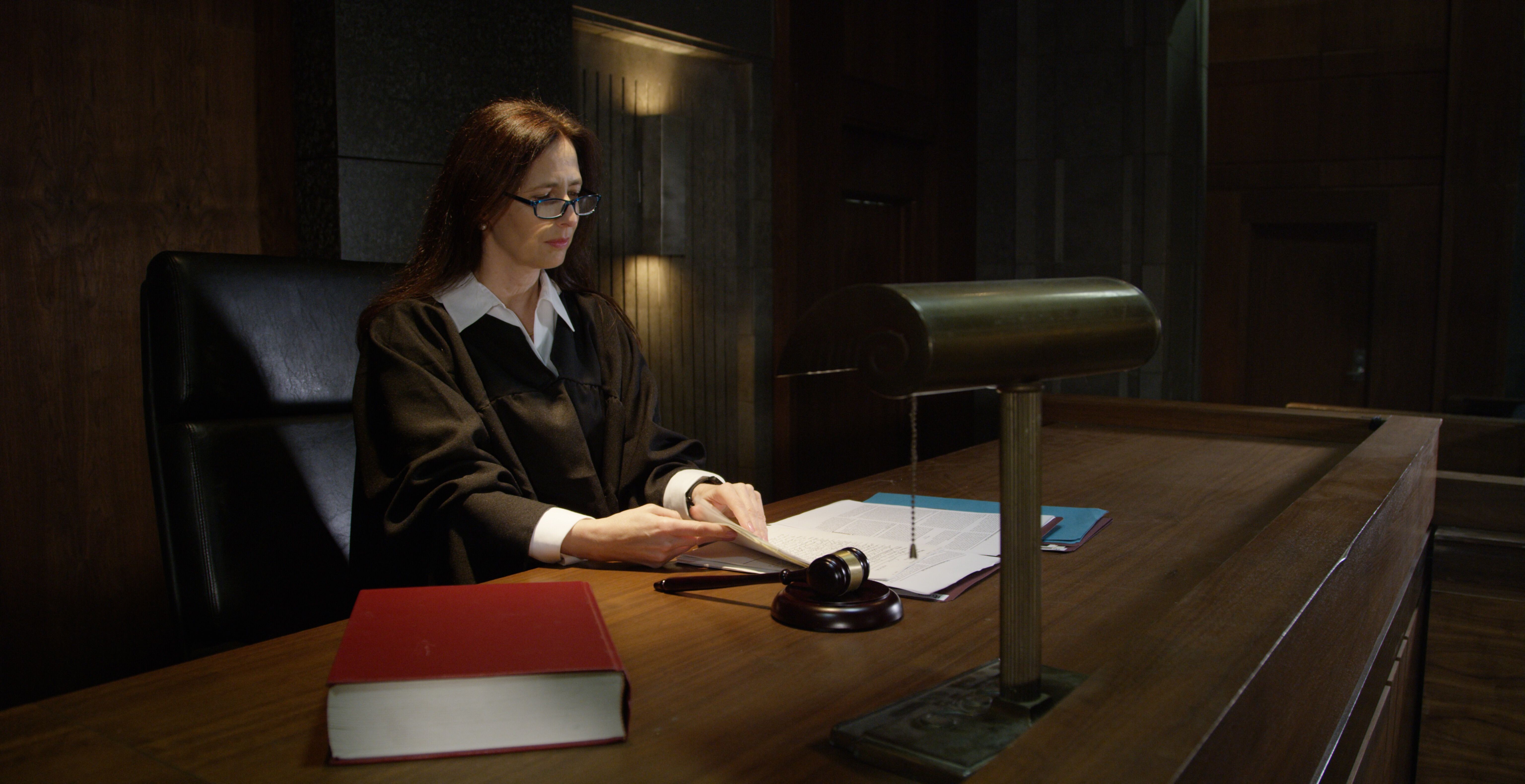 A female judge sitting on the bench in a courtroom