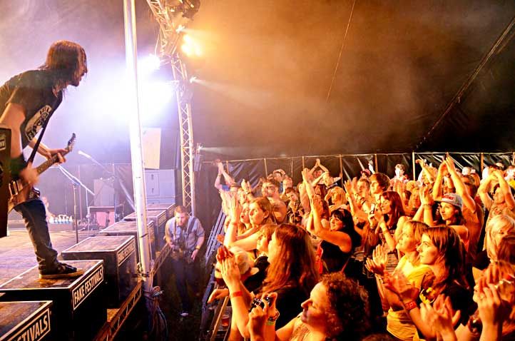 an artist performing on stage in front of a crowd