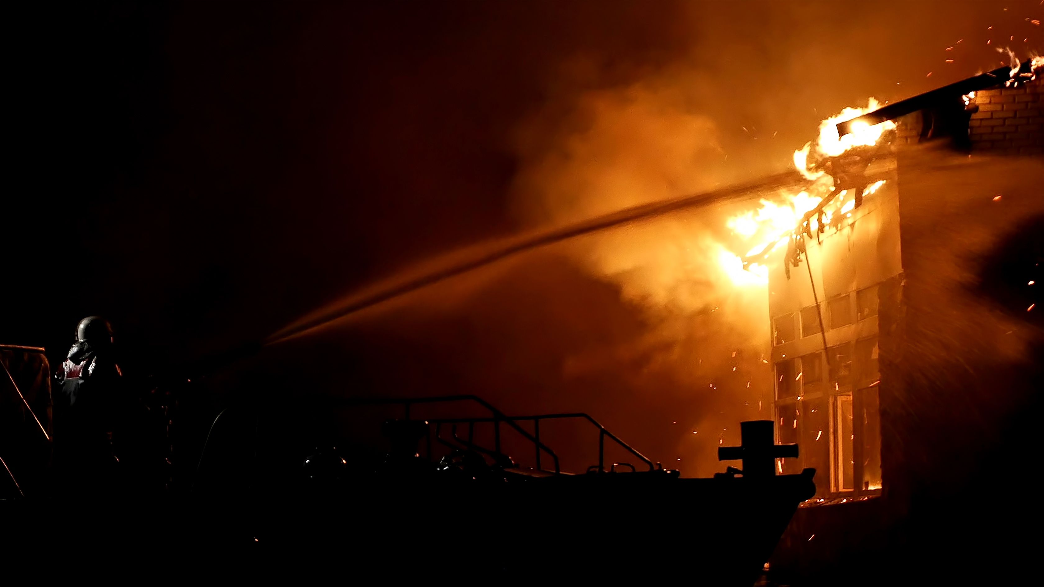 Fireman fighting fire in the dark