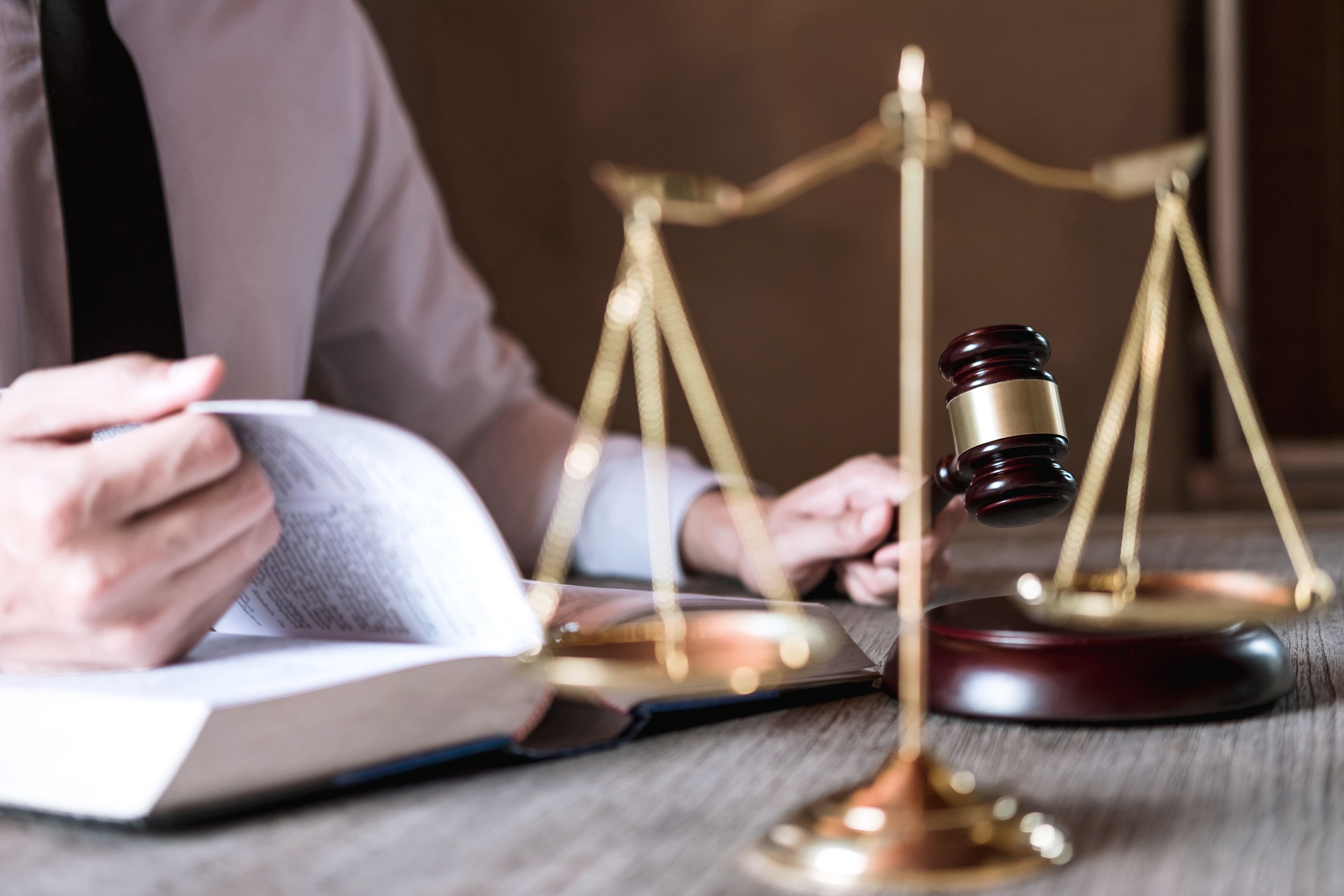 A male lawyer working in a courtroom sitting at the table