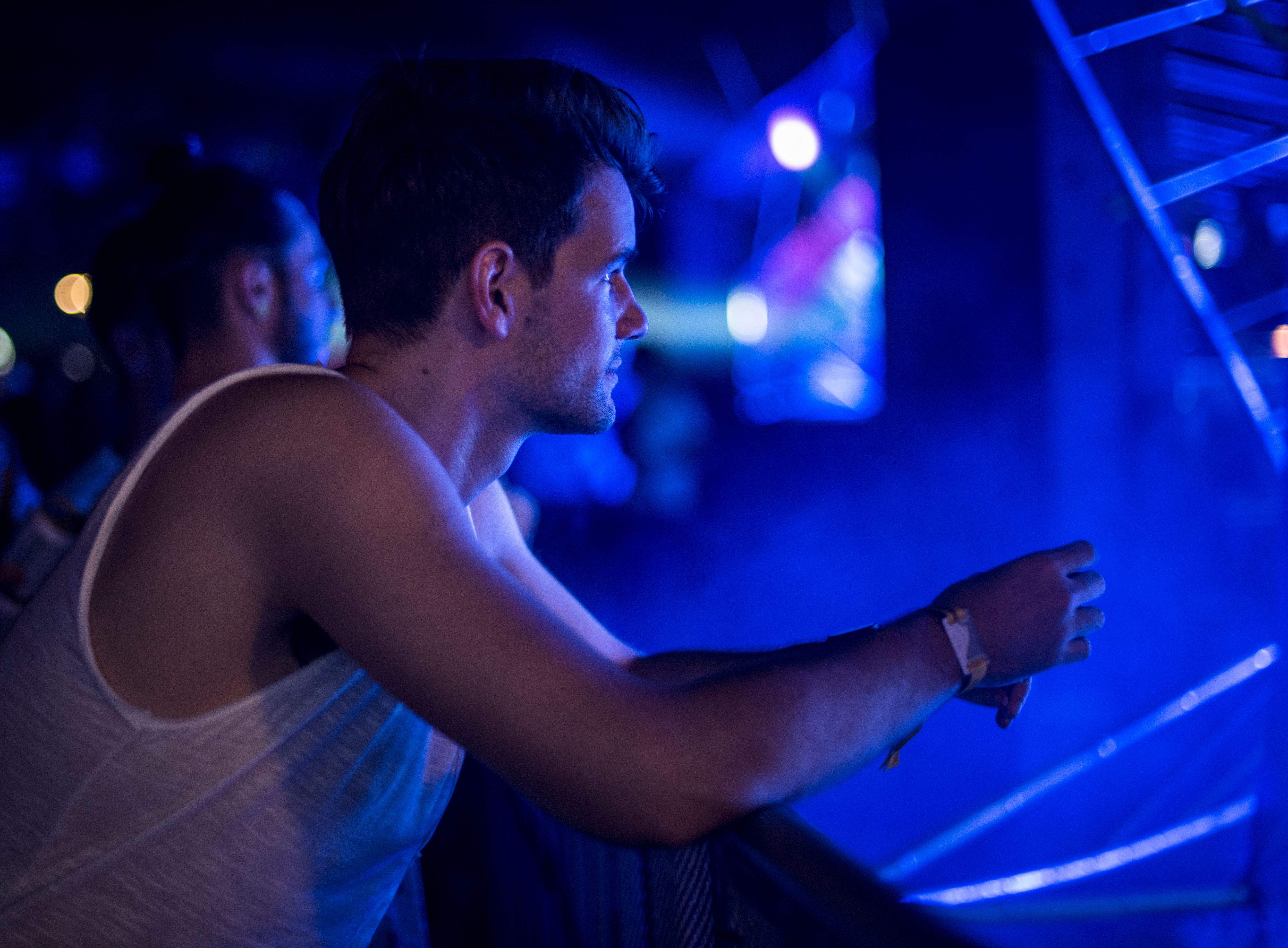 A man sitting alone watching a live concert