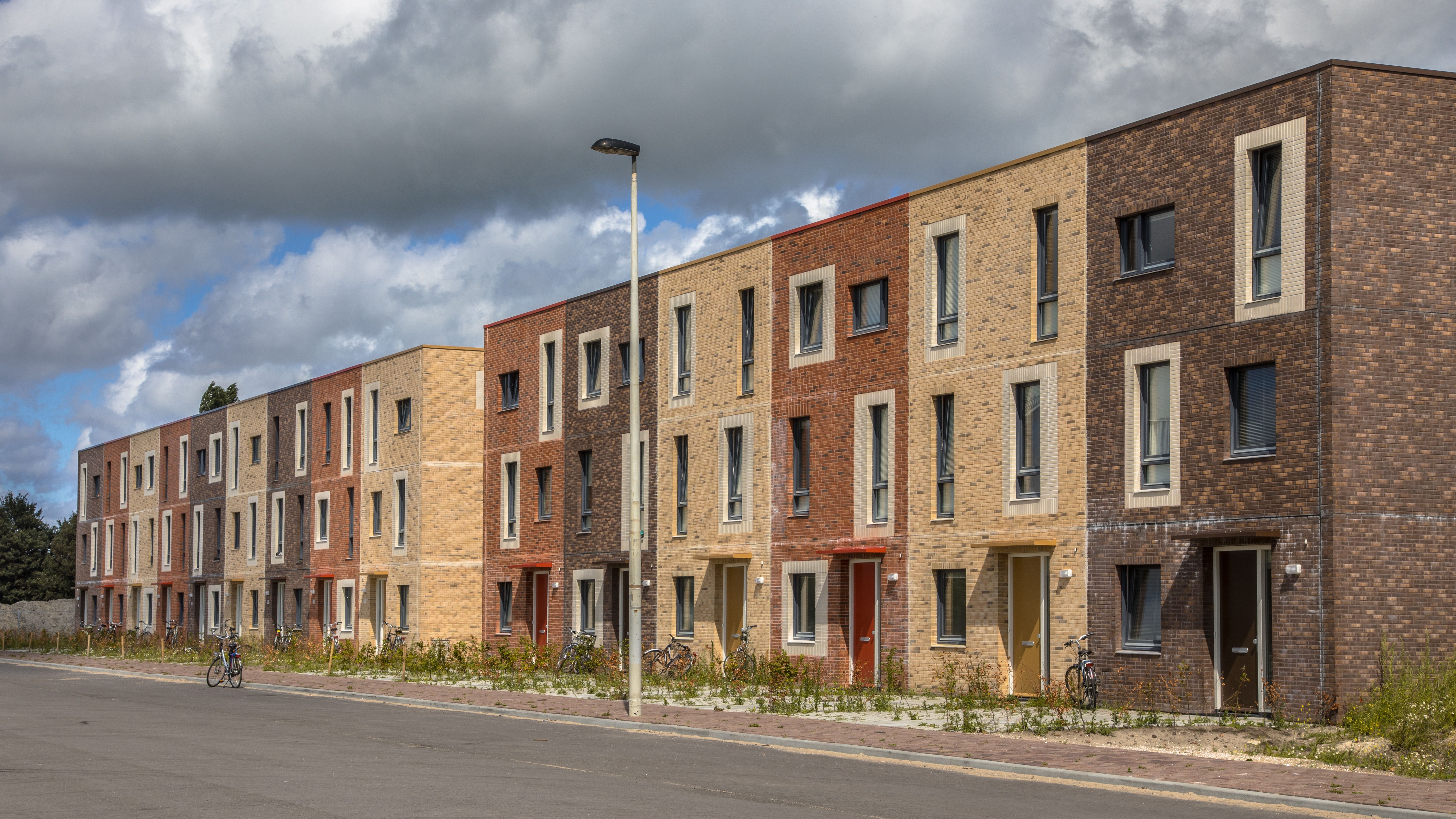 Modern social housing in terra colors containing modest family apartment houses