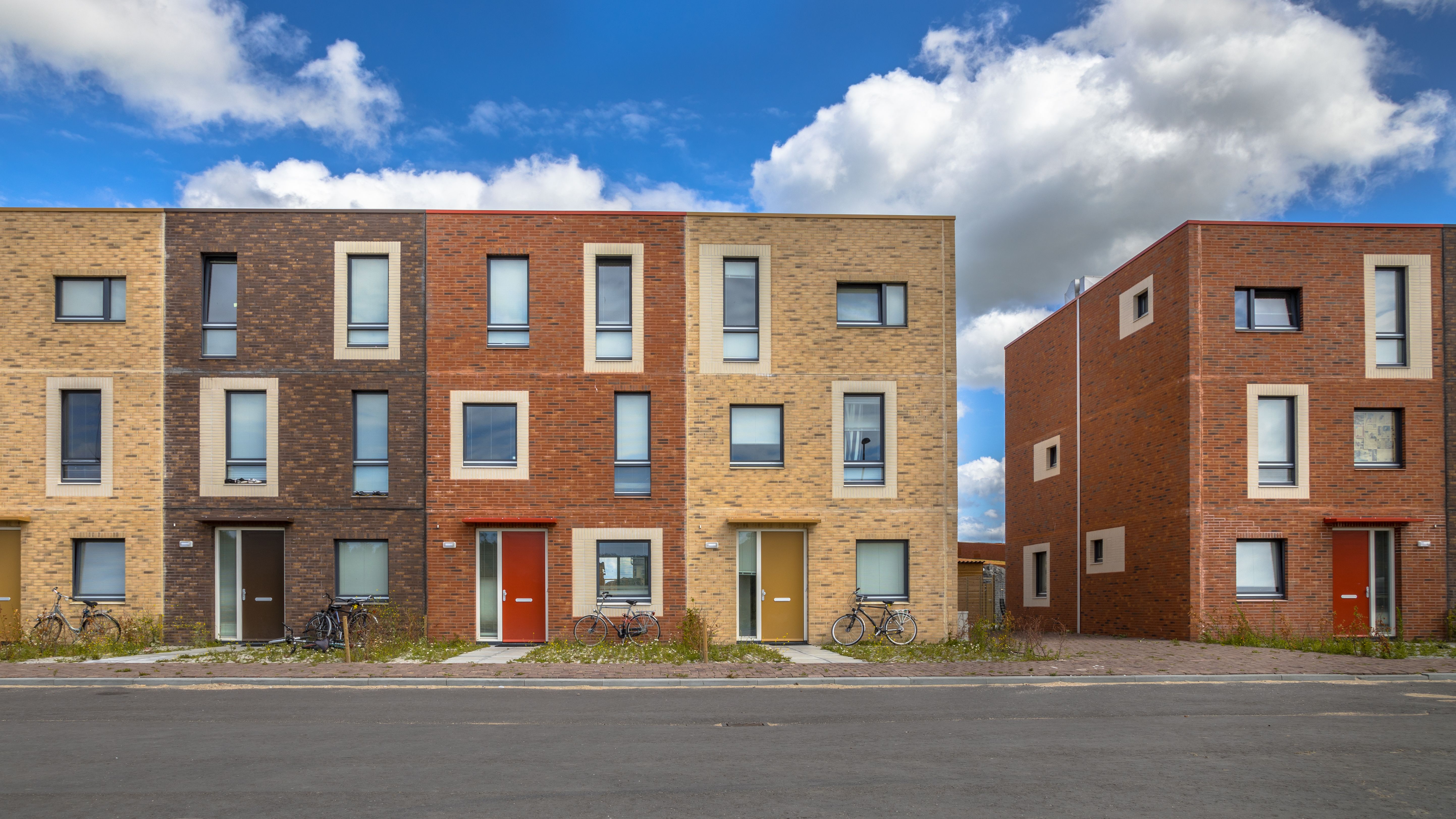 Modern social housing in terra colours containing modest family apartment