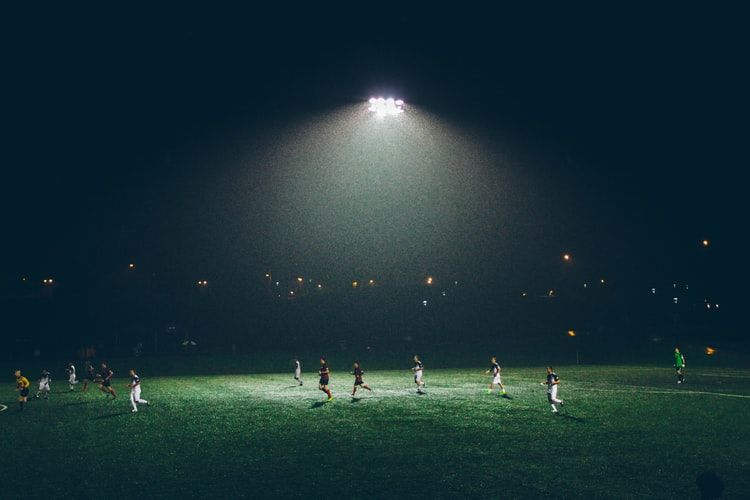 a group of people playing football in a stadium