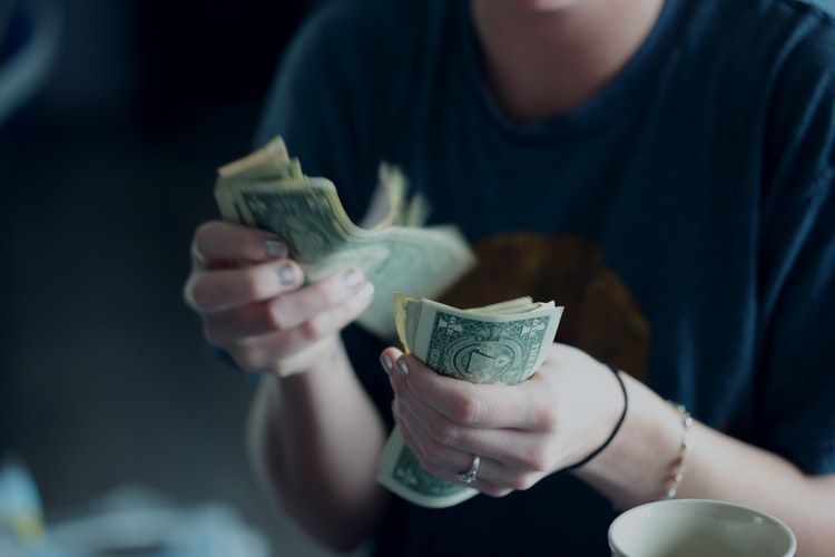 a person counting banknotes