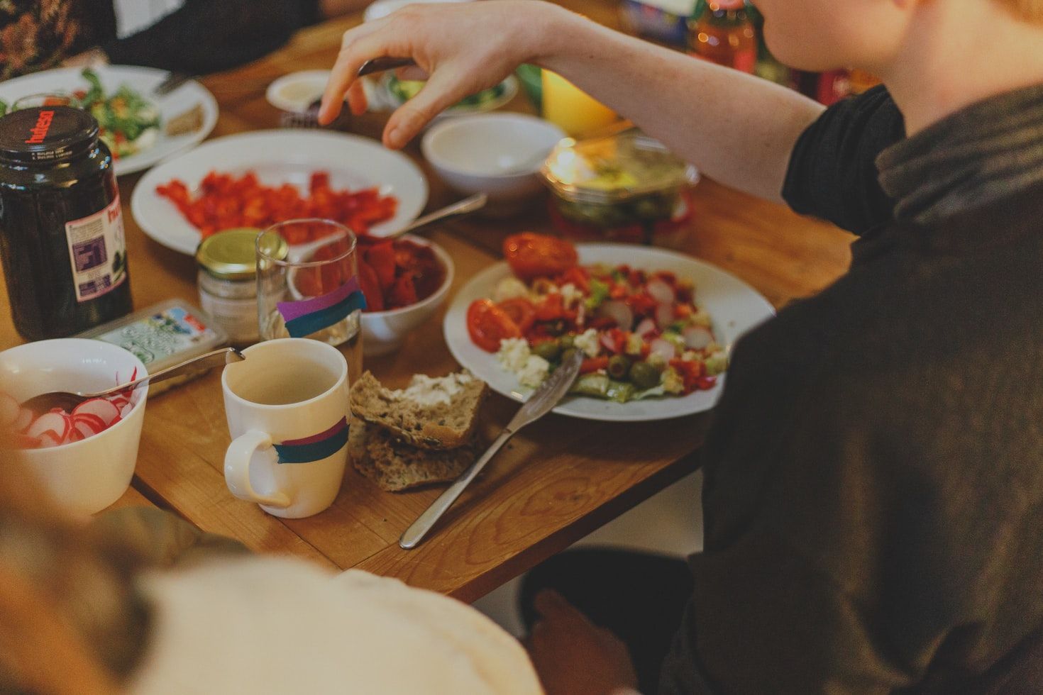 a person in front of a table with salad dish