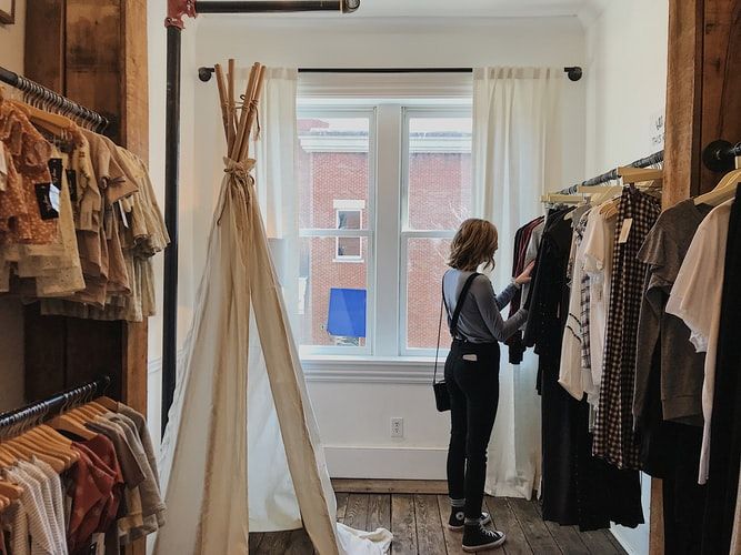 a woman selecting clothes in a store