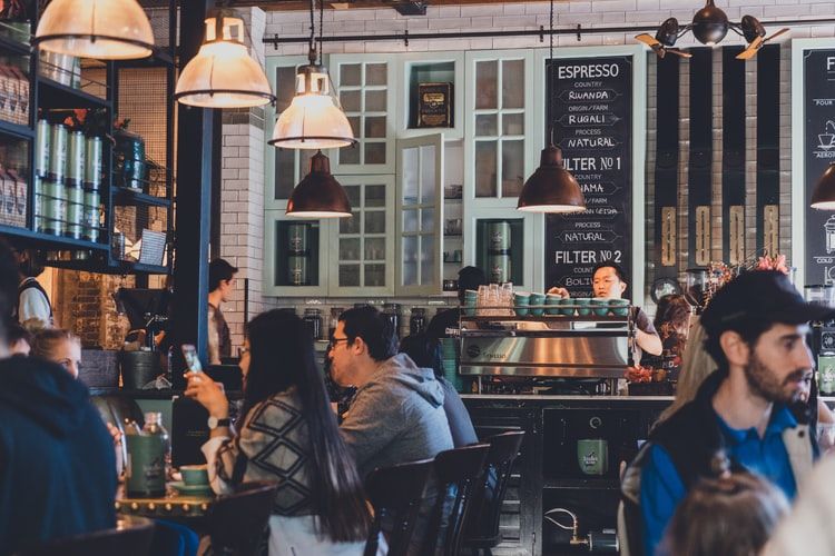 a group of people eating on a restaurant